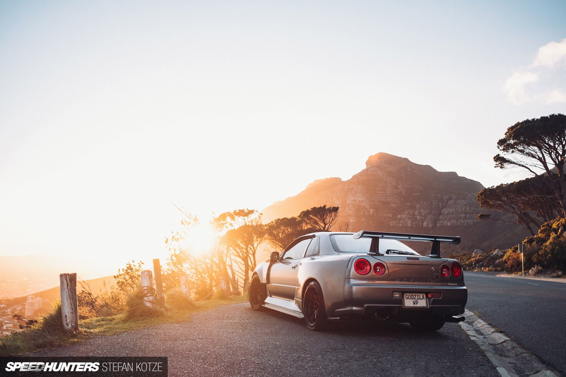 Nissan Skyline R34 GT-R with a sunset 
                    background