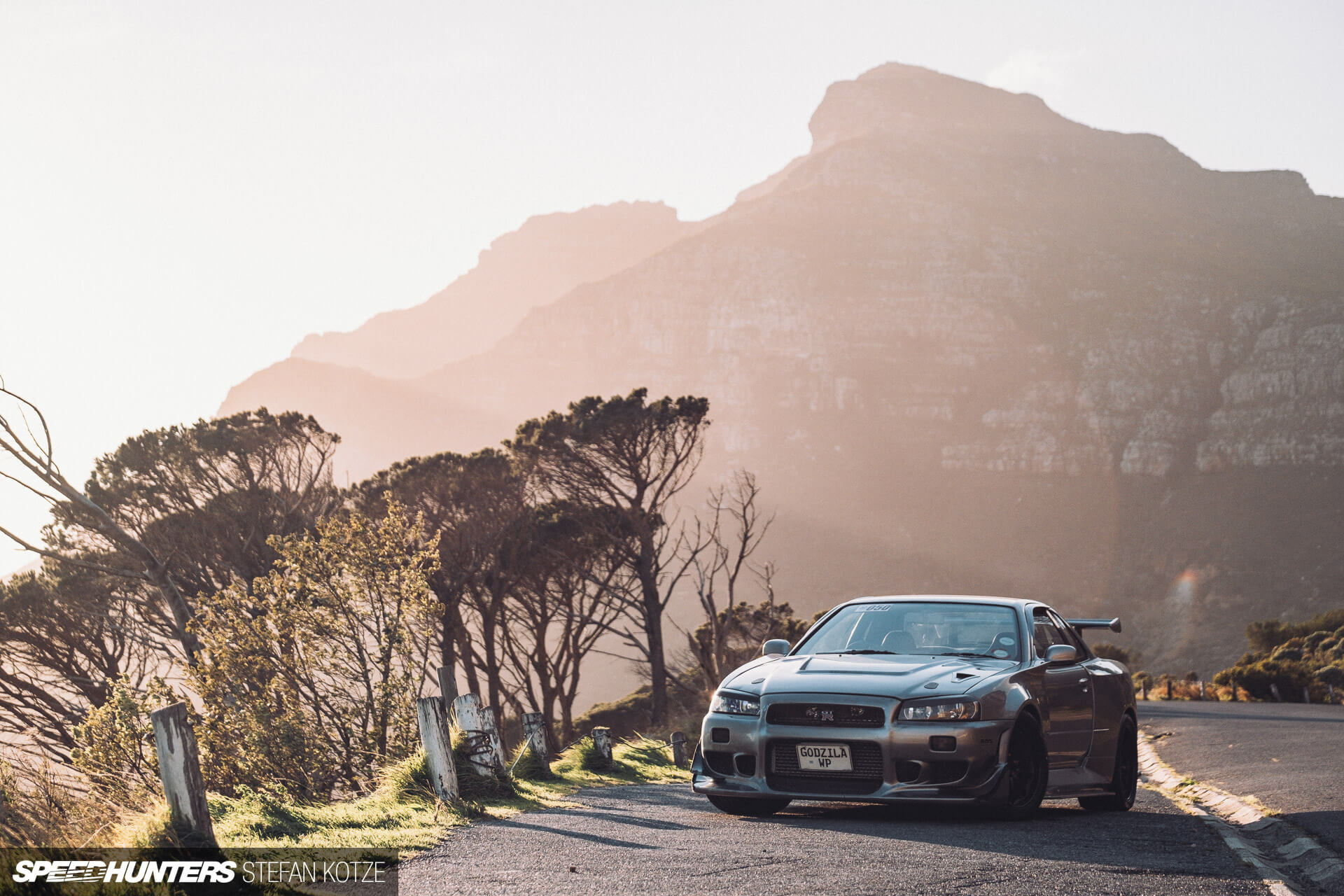 Nissan Skyline R34 GT-R in a mountain 
                    background