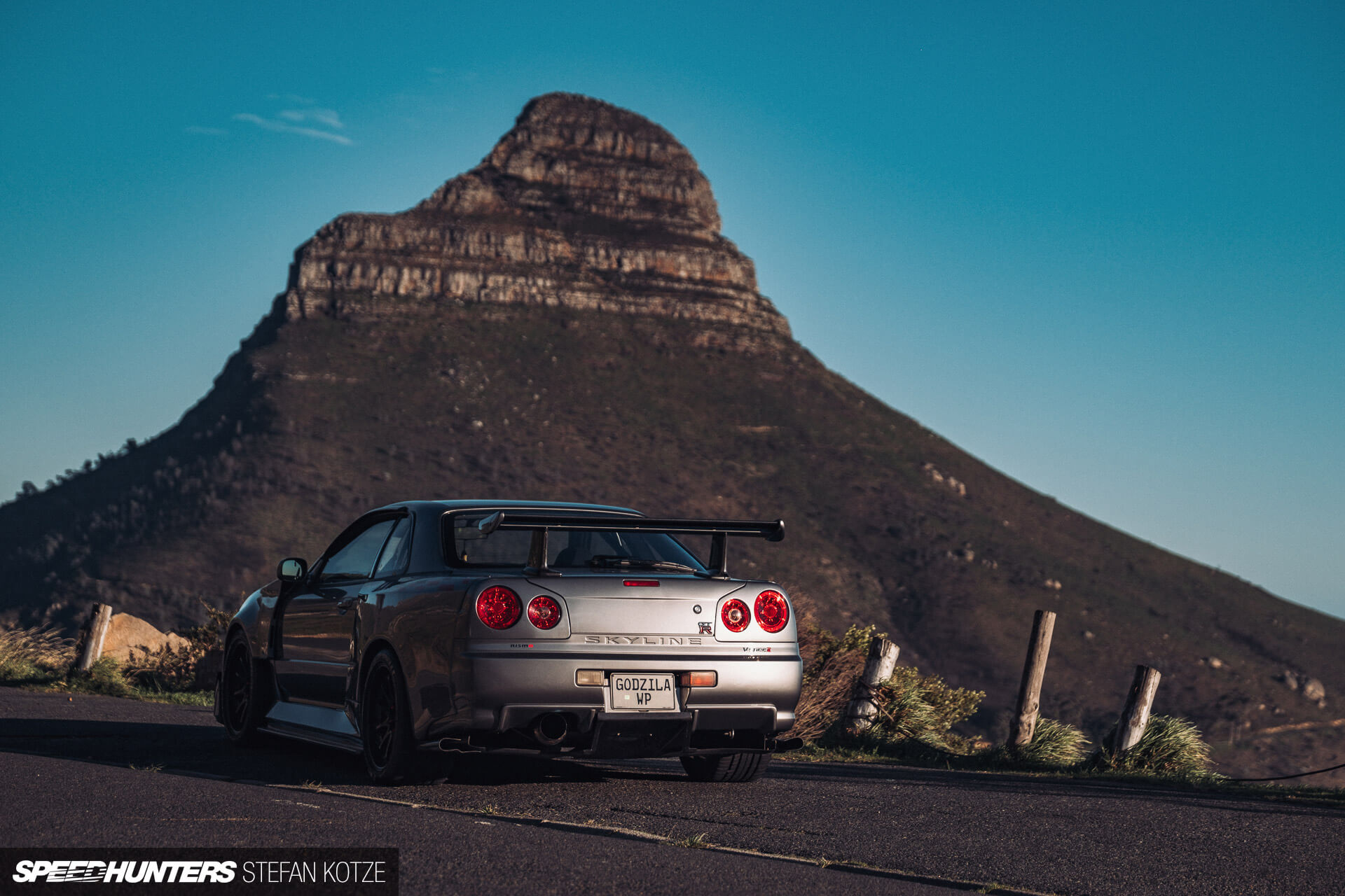 Nissan Skyline R34 GT-R  in a mountain 
                    background