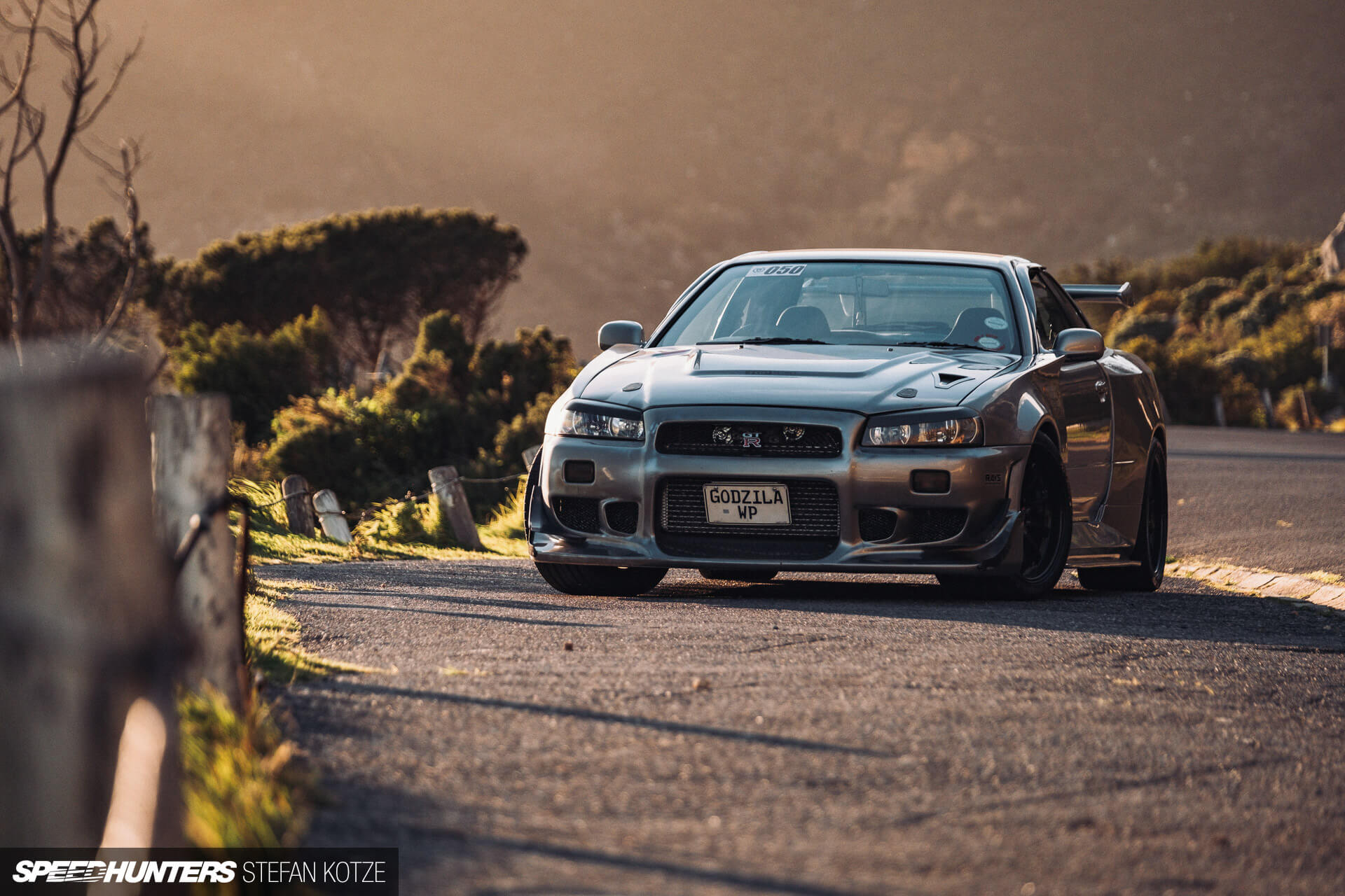 Nissan Skyline R34 GT-R on the side of a 
                    mountain road