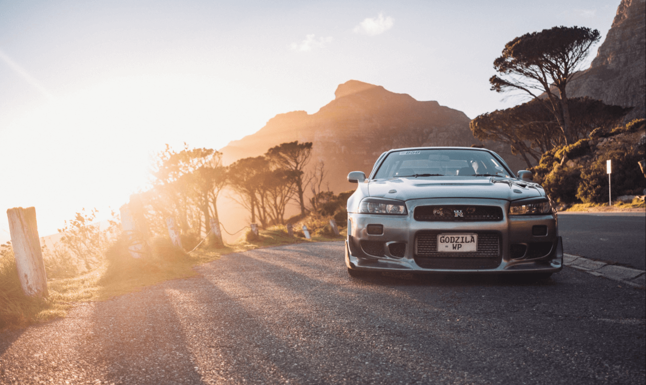 Side view of the Nissan Skyline R34 GT-R on a 
                    mountain road