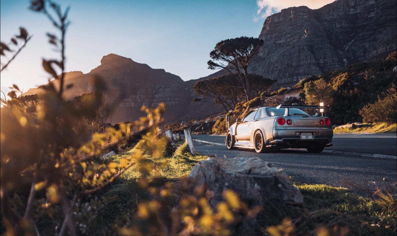 Nissan Skyline R34 GT-R seen from the front 
                    in a mountain landscape