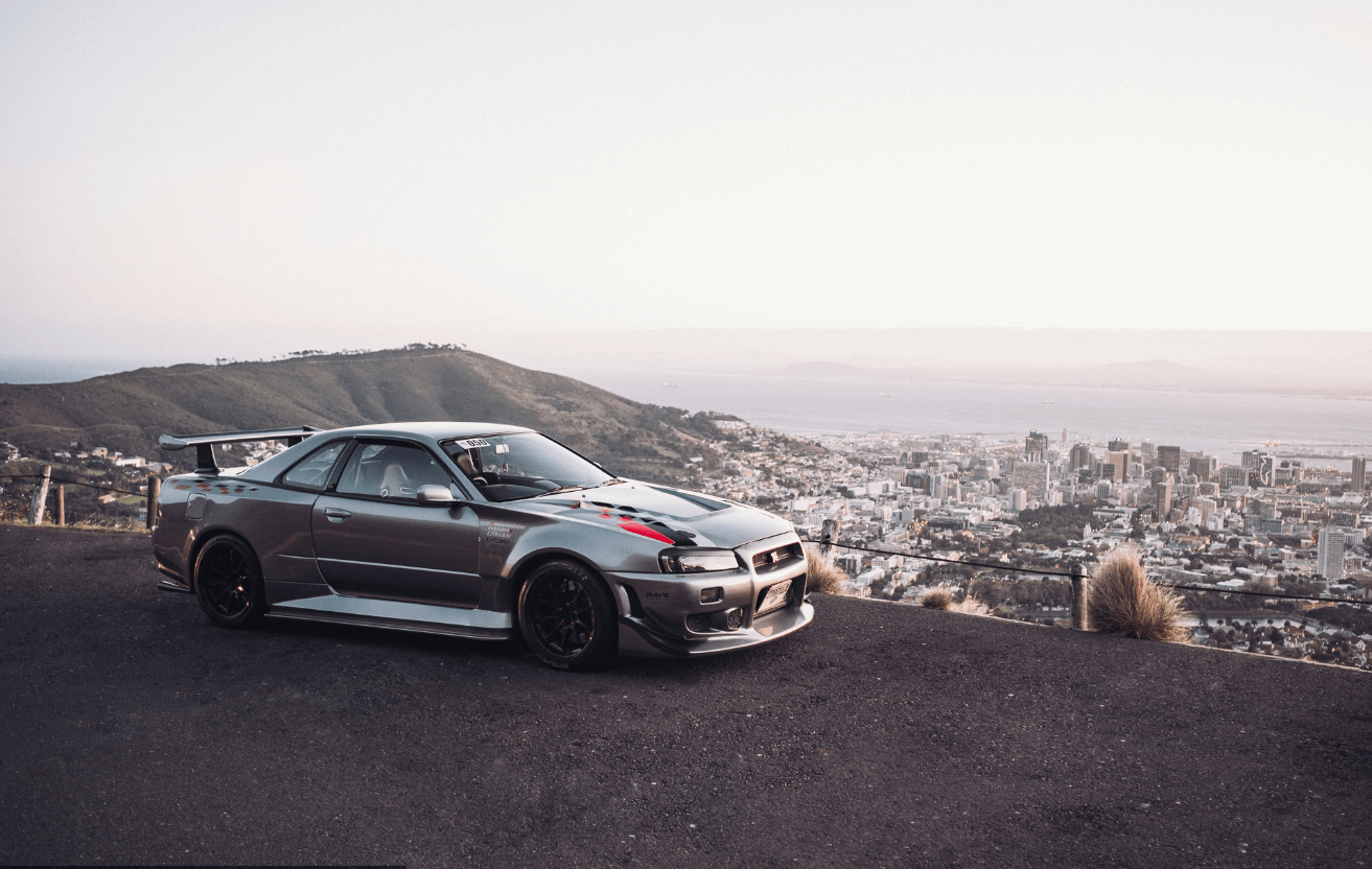 Nissan Skyline R34 GT-R with 
                a city background